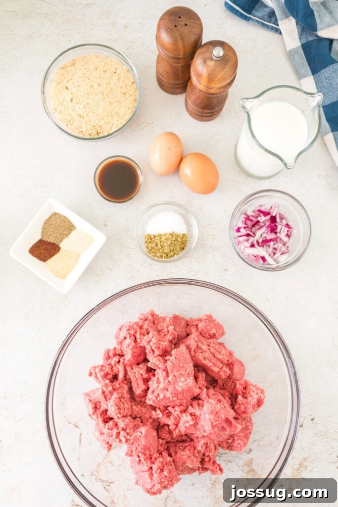 Pit Smoked Meatloaf 3 All the fresh ingredients for smoked meatloaf meticulously arranged on a countertop, including ground beef, a selection of vibrant spices, farm-fresh eggs, creamy milk, and golden breadcrumbs.
