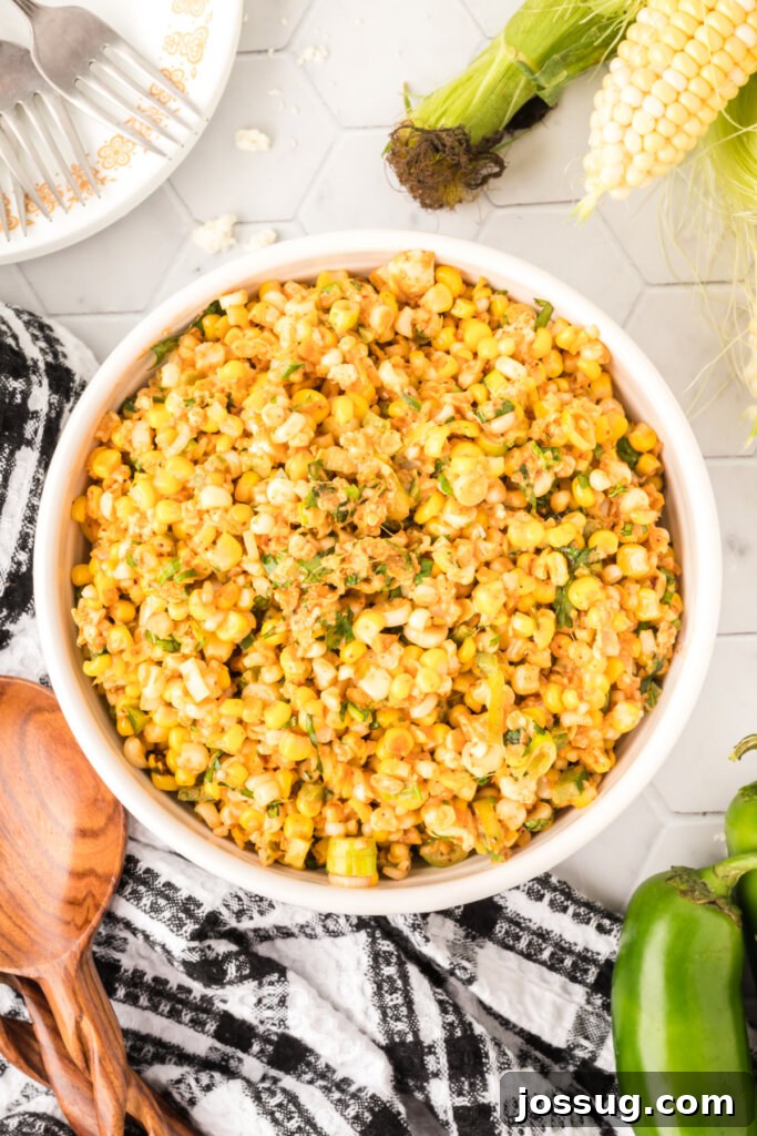 Zesty Elote Salad 13 looking down into a bowl of mexican street corn salad, garnished with fresh cilantro and chili powder