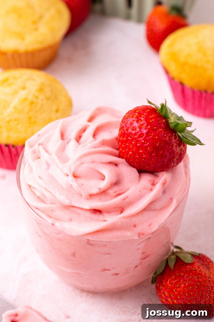 Velvet Strawberry Buttercream 5 A charming glass jar filled with luscious strawberry buttercream frosting, topped with a fresh, ripe strawberry