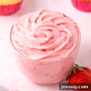 Fresh strawberry buttercream frosting in a glass jar, beautifully presented and ready for use