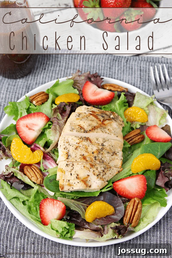 A beautifully arranged California Chicken Salad in a pristine white bowl, ready to be enjoyed with a fork.