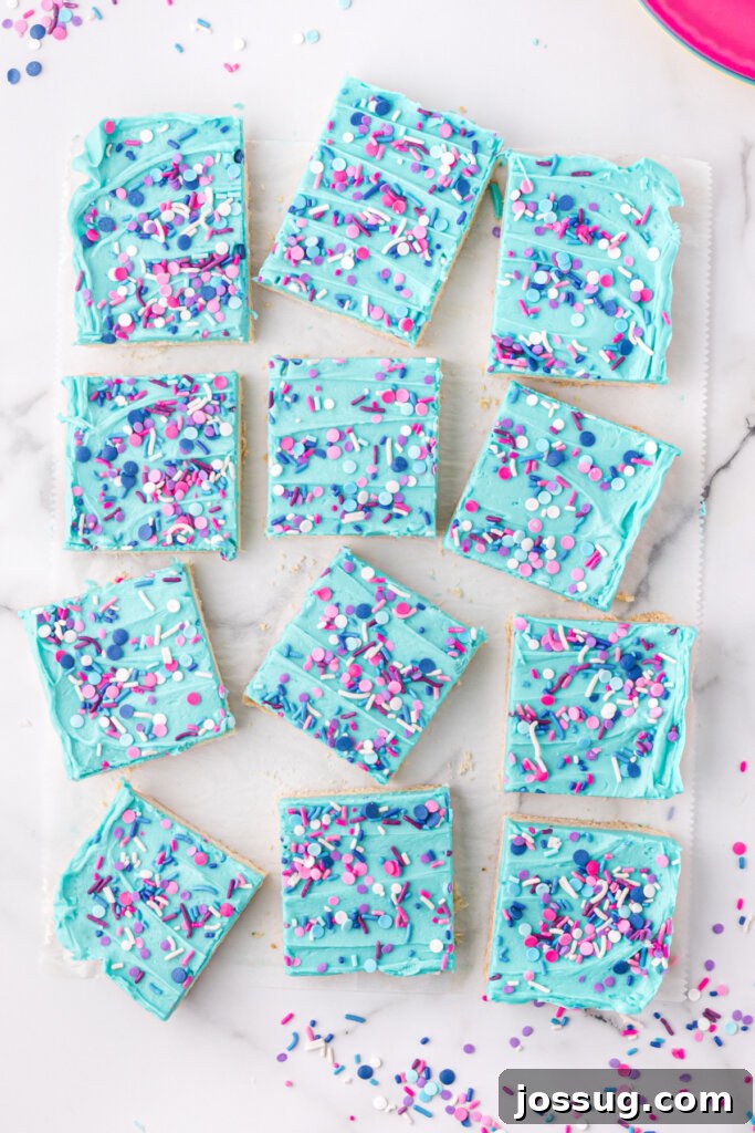 Close-up view of frosted sugar cookie bars cut into squares.