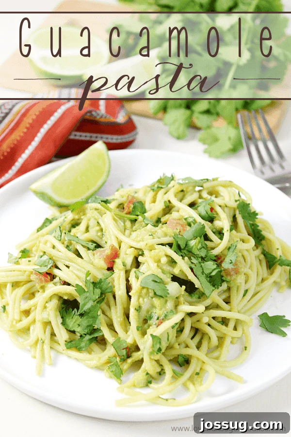 Creamy Guacamole Pasta 2 A tantalizing bowl of Guacamole Pasta on a pristine white plate, accompanied by a fork, ready to be enjoyed. Fresh cilantro and a lime wedge garnish the dish, highlighting its vibrant flavors.