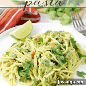 Guacamole Pasta on a white plate with a fork.