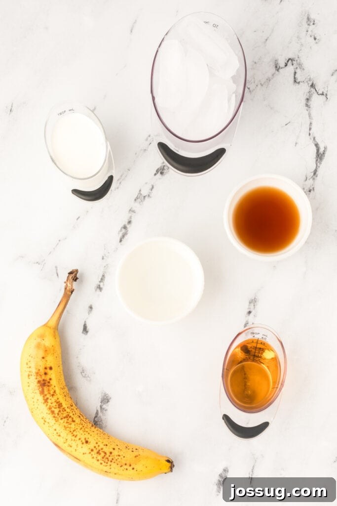 All essential ingredients for a Dirty Banana Cocktail meticulously measured and displayed on a sleek marble surface, including a ripe banana, various rum and liqueurs, ice cubes, and half-and-half.