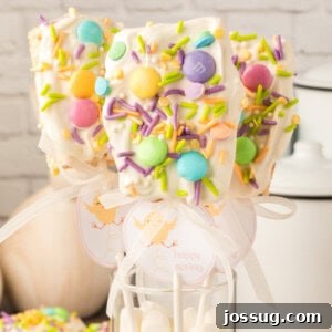 Three colorful Spring Rice Krispies Treats Pops in a decorative jar, showcasing their appeal as a festive spring and Easter dessert.