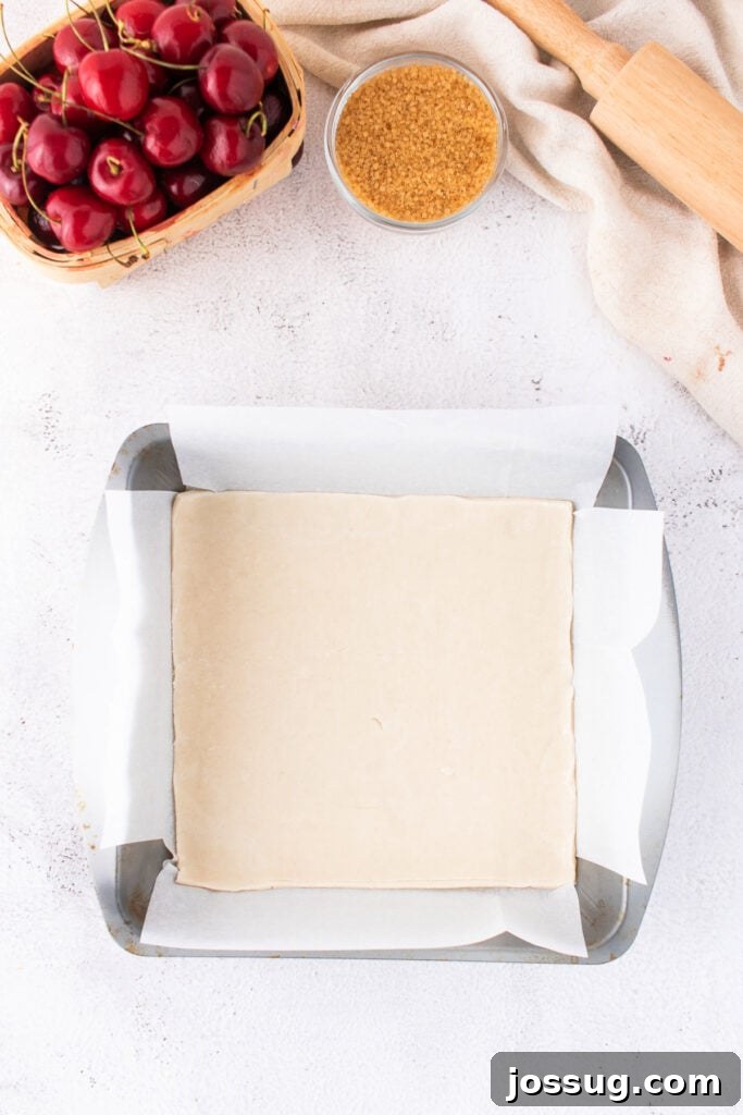 Sweet Cherry Pie Bars 7 Unbaked bottom pie crust pressed into a parchment-lined 8x8 inch baking pan