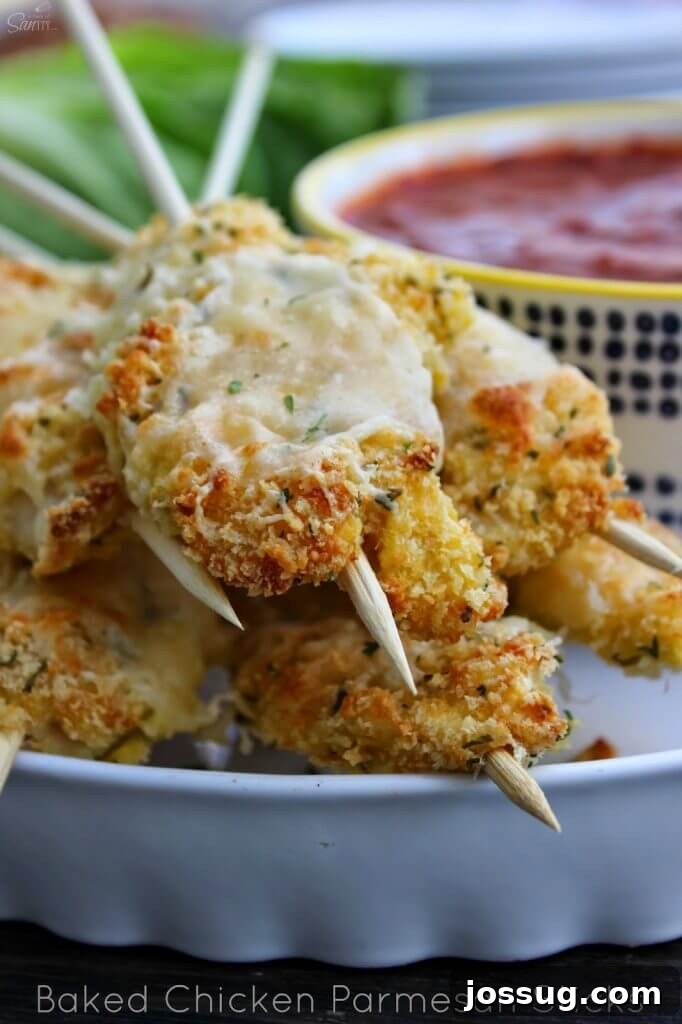 Decadent Dark Cherry Almond Crunch Bars 6 Baked Parmesan Chicken Sticks on a white plate closeup to show texture of food.