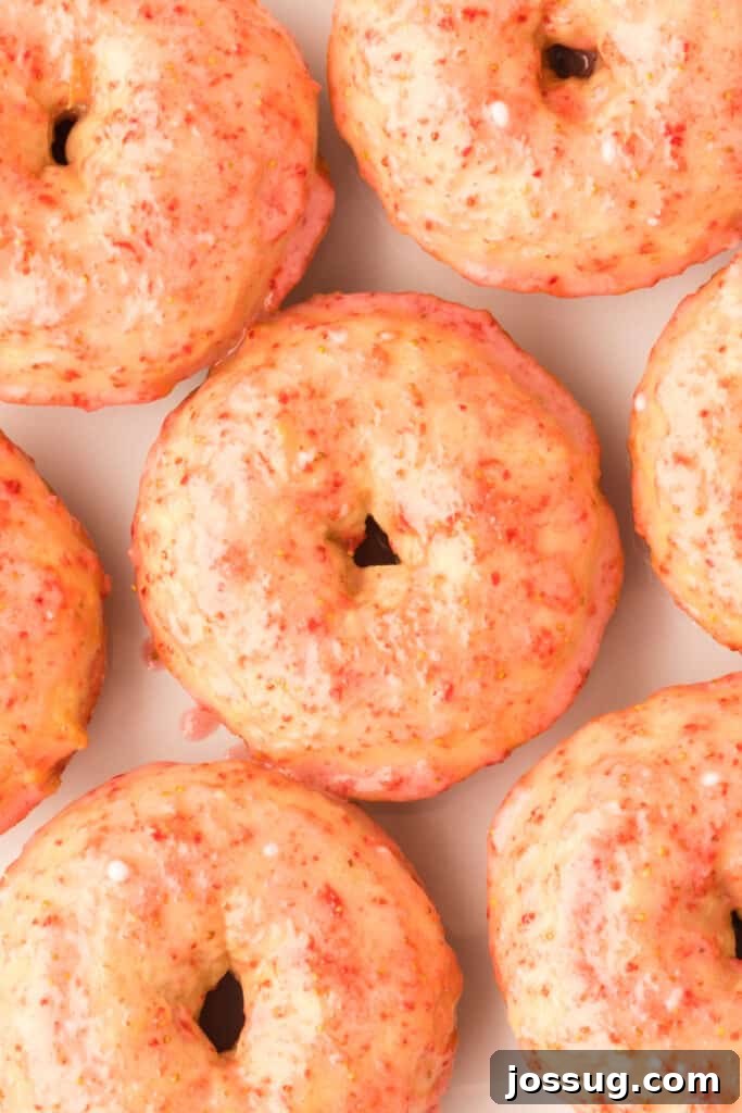 Strawberry Kissed Vanilla Cake Donuts 3 closeup of vanilla cake donuts with fresh strawberry glaze
