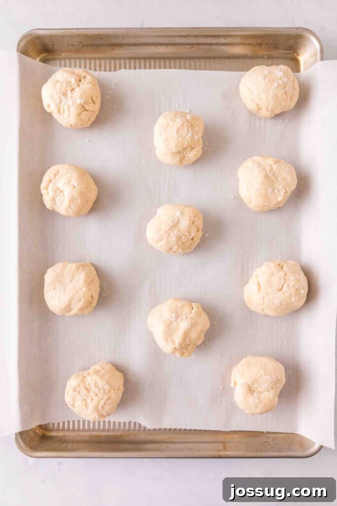 Amazing 3 Ingredient Scones 8 Raw, unbaked scone dough balls neatly arranged in even rows on a parchment-lined baking sheet, prepared for the oven and ready to puff up.
