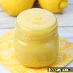 Bright Homemade Lemon Curd 2 A close-up shot of vibrant yellow homemade lemon curd in a clear glass jar, ready to be enjoyed.