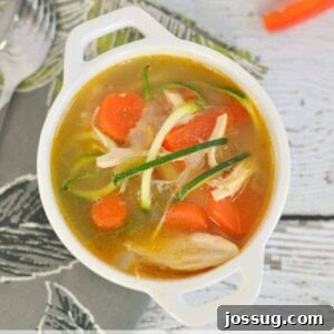 Southwestern Chicken Zoodle Soup in a white bowl, garnished.