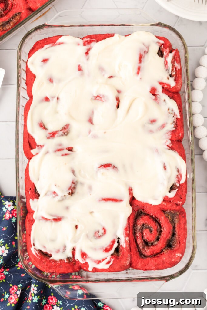 red velvet cinnamon rolls with cream cheese icing in pan