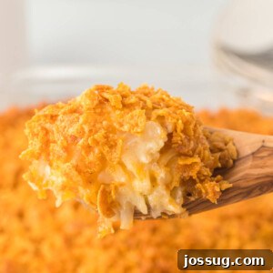 Hash Brown Casserole scoop on wooden spoon