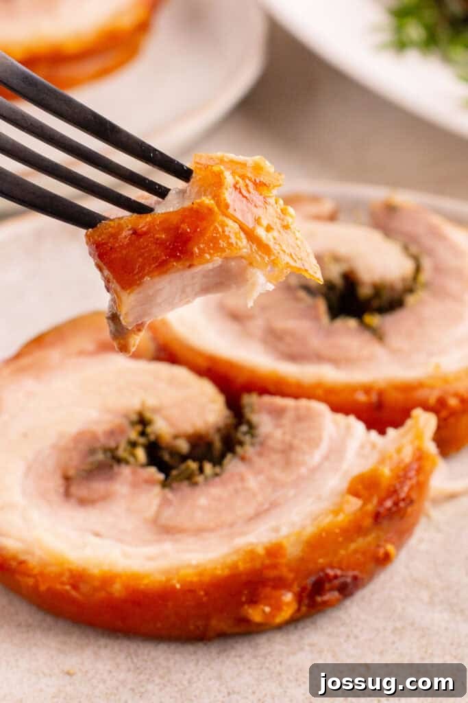 Crispy Porchetta Perfection 15 Fork holding a perfect bite of porchetta with crispy skin and juicy meat, ready to eat