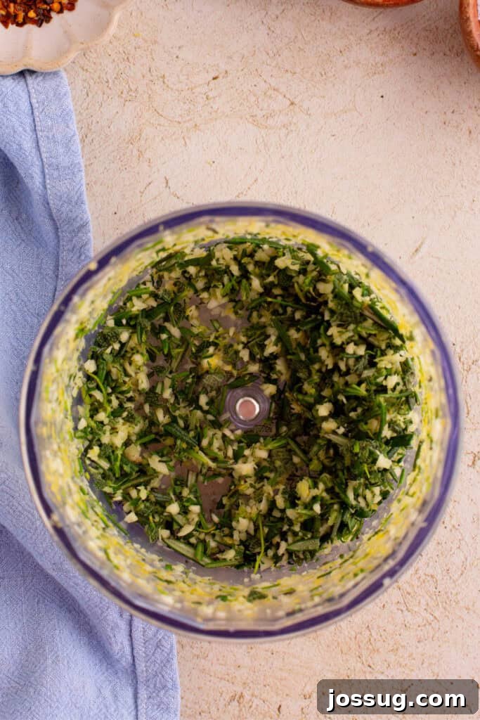 Crispy Porchetta Perfection 6 Finely chopped herb and garlic mixture after processing, showing a vibrant green paste