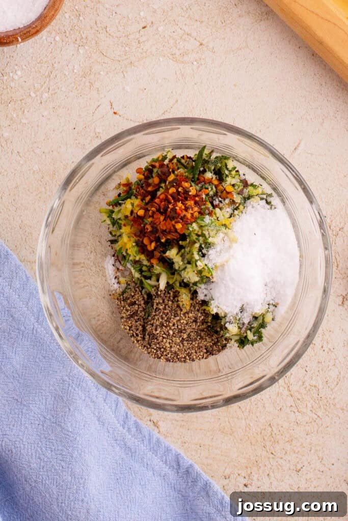 Crispy Porchetta Perfection 7 Herb mixture combined with salt, pepper, and red pepper flakes in a bowl, showing the complete seasoning blend