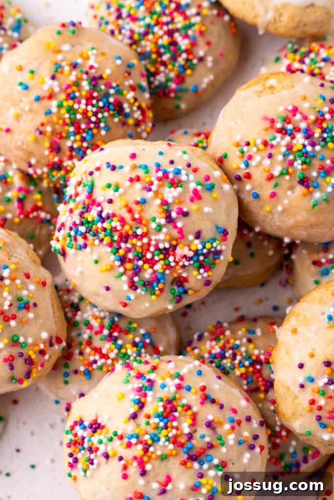 Pillowy Italian Ricotta Cookies 2 Overhead close-up of glazed and sprinkled Italian Ricotta Cookies grouped together, highlighting their festive appearance and soft texture