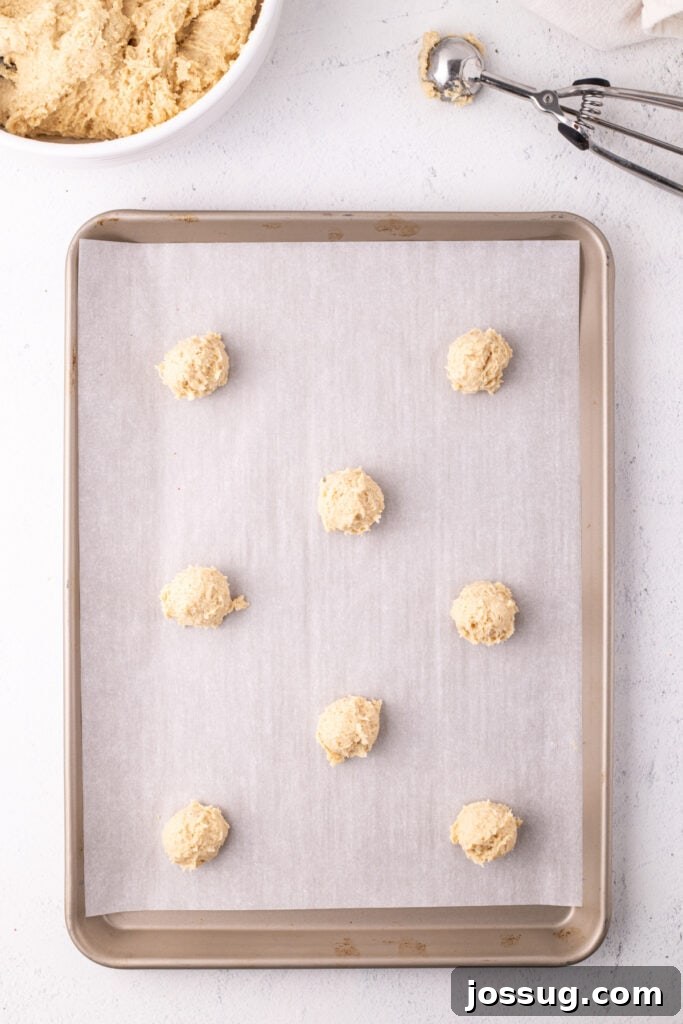 Pillowy Italian Ricotta Cookies 11 Scooped dough balls spaced on a parchment-lined baking sheet, ready for the oven