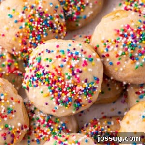 Square crop of glazed Italian Ricotta Cookies with colorful sprinkles