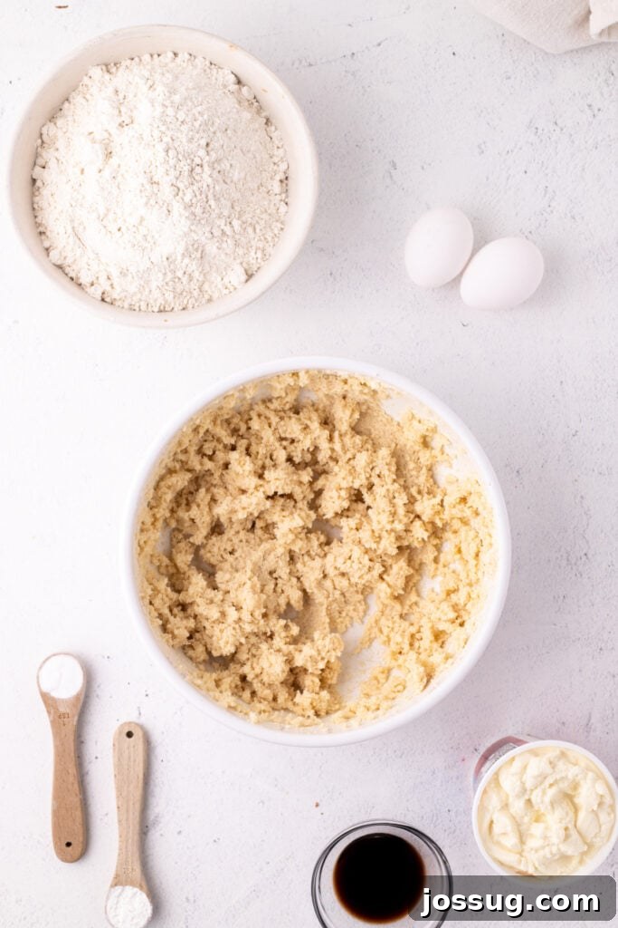 Pillowy Italian Ricotta Cookies 6 Creamed butter and sugar mixture in a bowl surrounded by remaining wet ingredients, demonstrating the next step