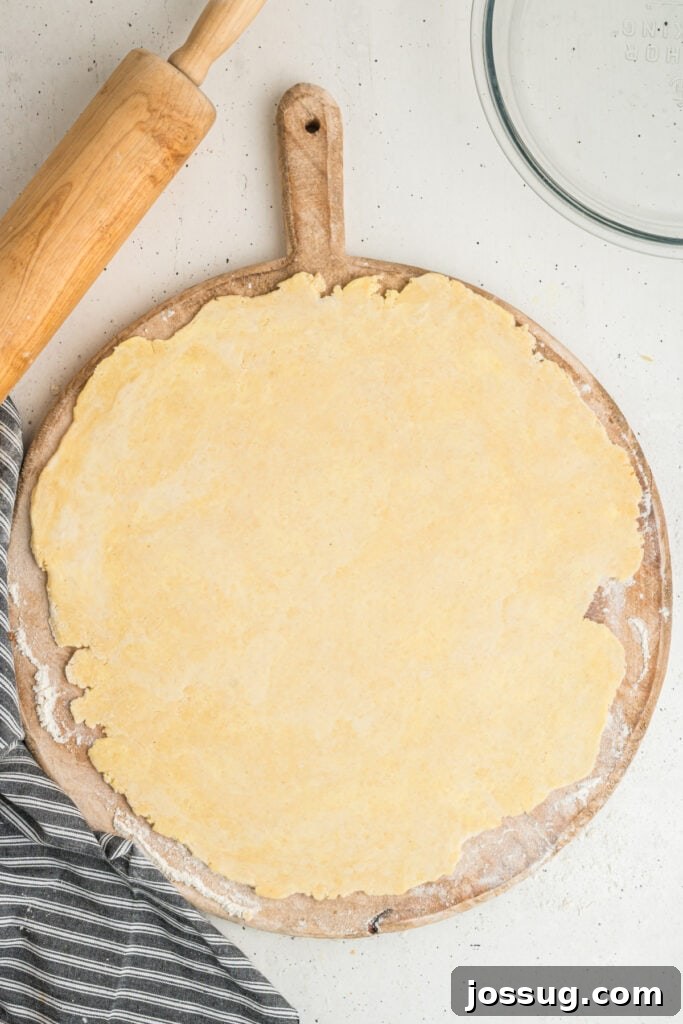 Rolled out butter pie crust dough ready to be transferred to pie dish