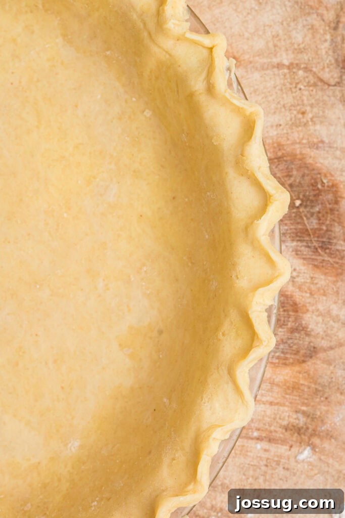 Close-up of fluted edge on butter pie crust pressed into a pie dish