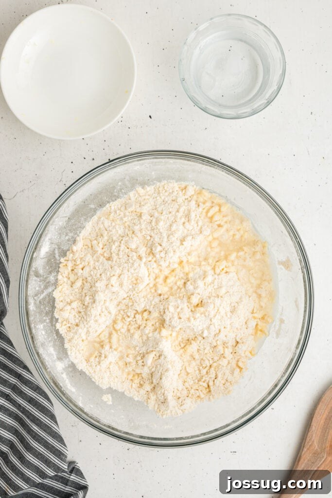 Ice water added to flour and butter mixture for pie dough