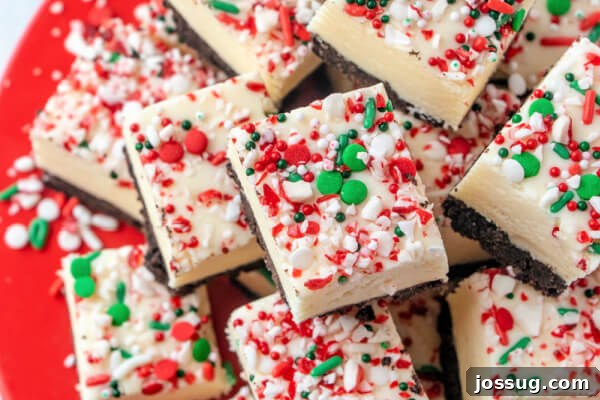Pieces of white chocolate peppermint fudge beautifully arranged on a vibrant red plate.