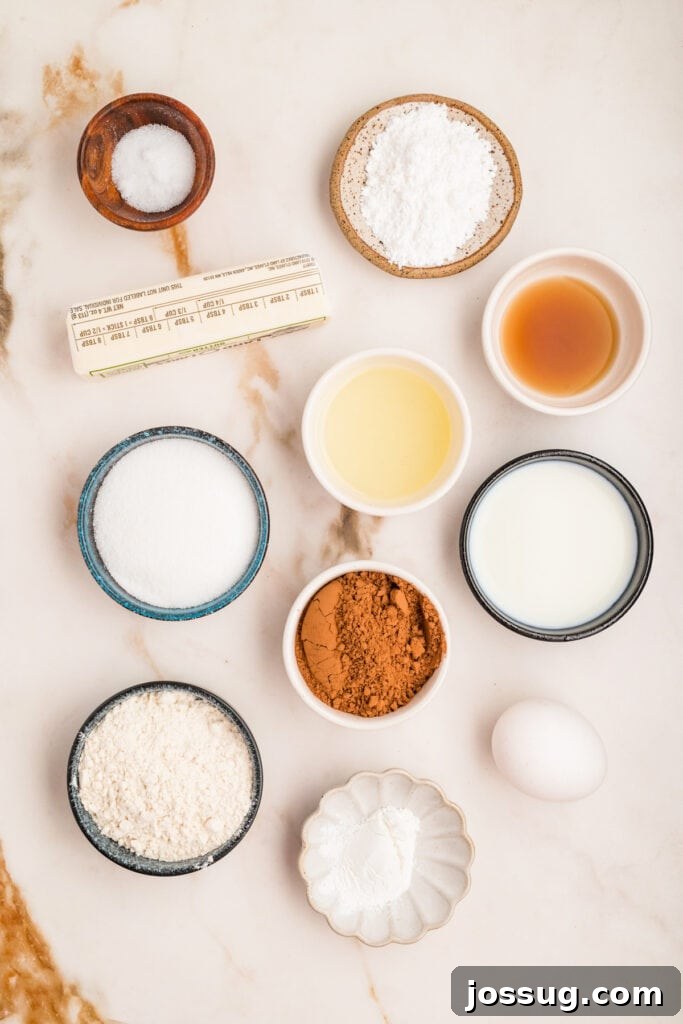 Overhead shot of ingredients for chocolate donut holes arranged on marble surface