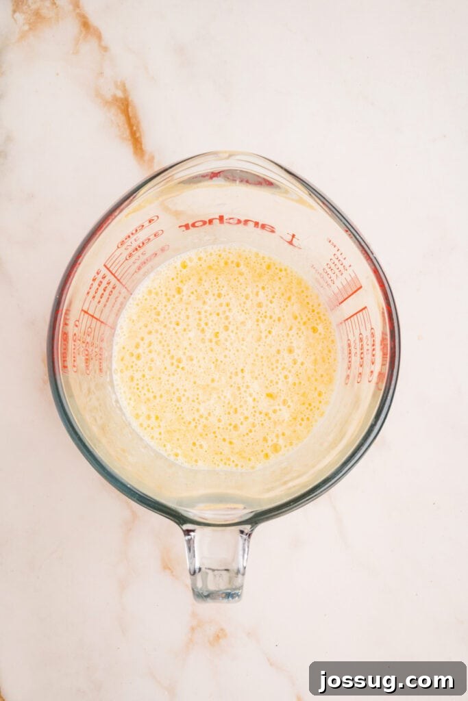 Wet ingredients whisked together in a measuring cup until frothy