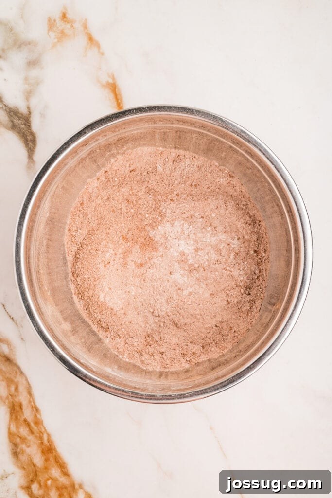 Whisked dry ingredients fully combined in a mixing bowl