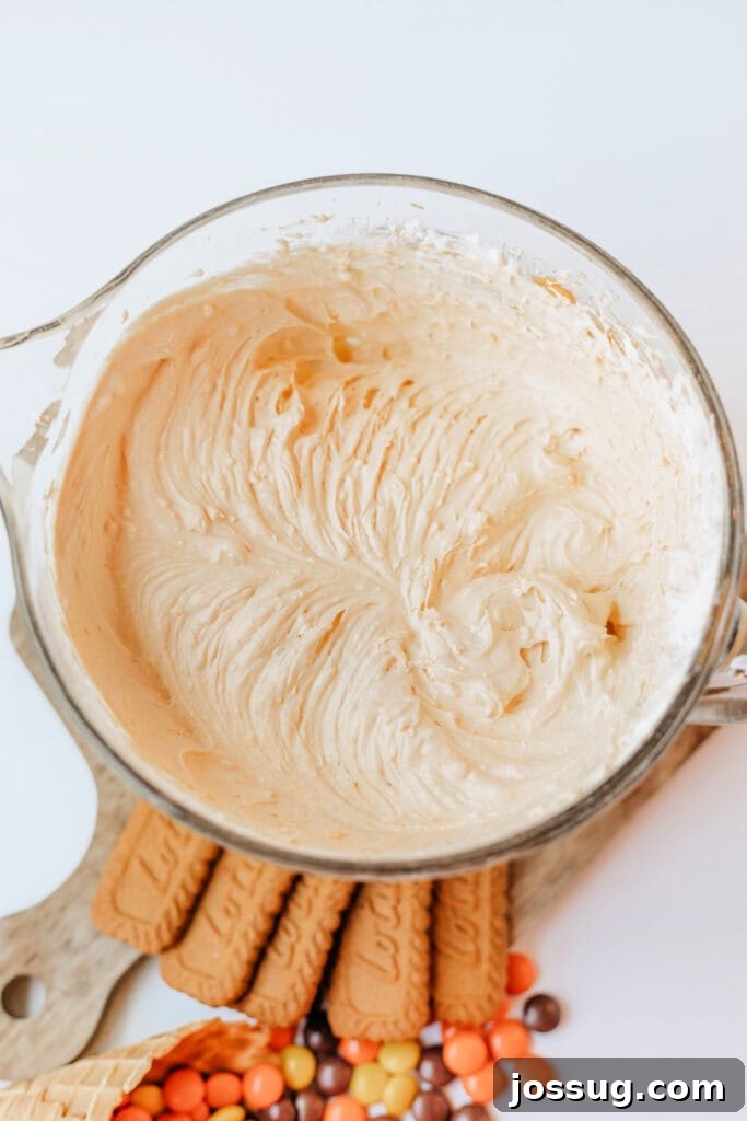 Pumpkin cheesecake filling fully mixed, light and fluffy in texture, ready for piping into the cones.
