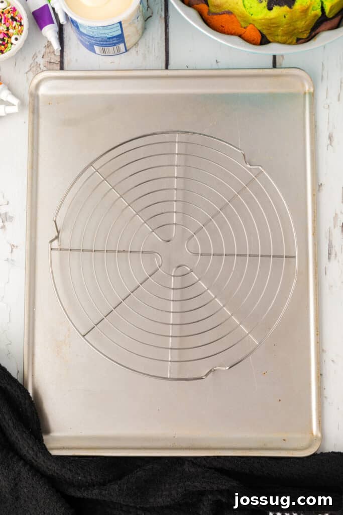 Bewitched Bundt Cake 16 Cooling rack placed on top of a baking sheet, ready for transferring the bundt cake.