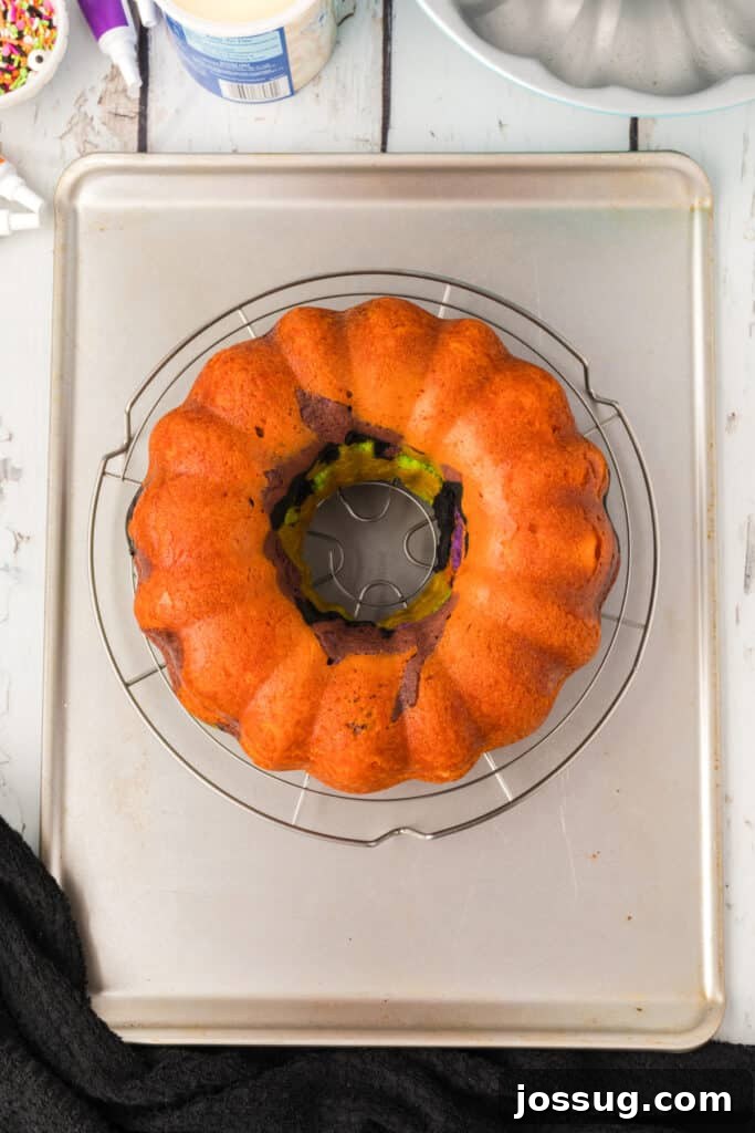Bewitched Bundt Cake 17 Halloween Bundt Cake inverted onto a wire rack over a baking sheet after baking.