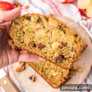 A slice of moist apple zucchini bread, ready to eat