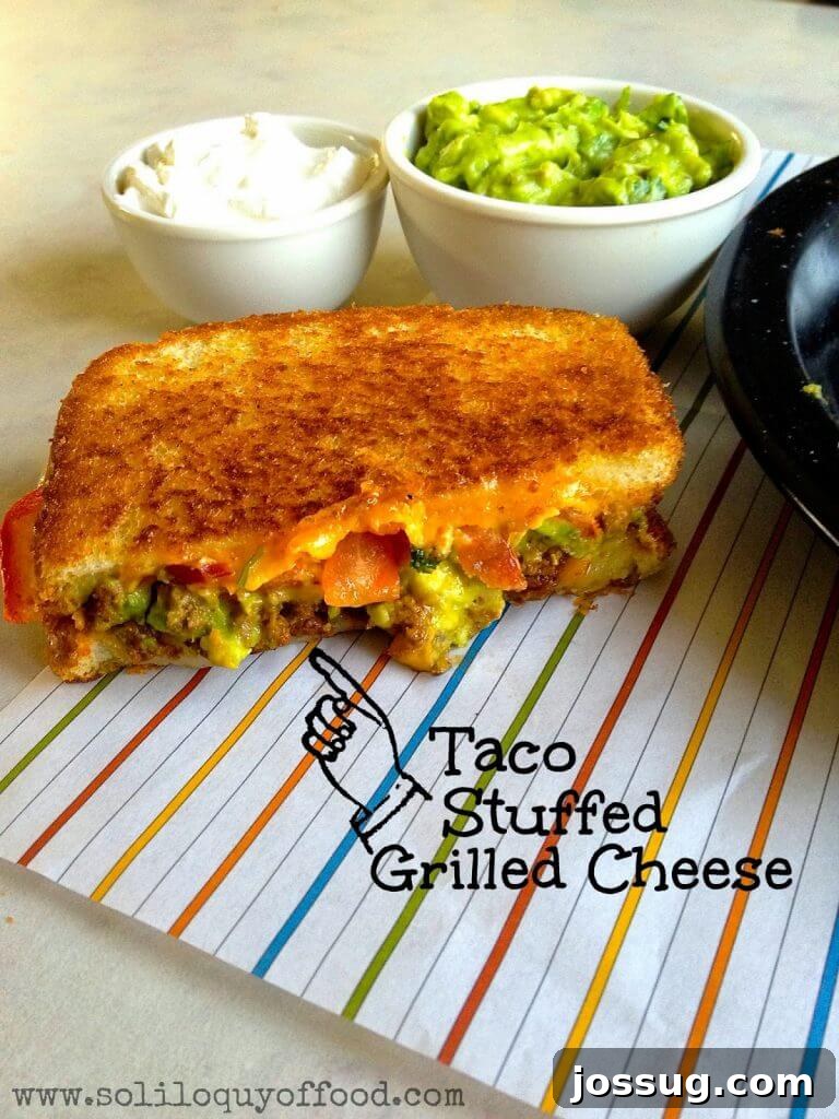 Pepperoni Pizza Melt with Garlic Herb Butter Crust 3 Half of a taco stuffed grilled cheese sandwich on a plate mat.