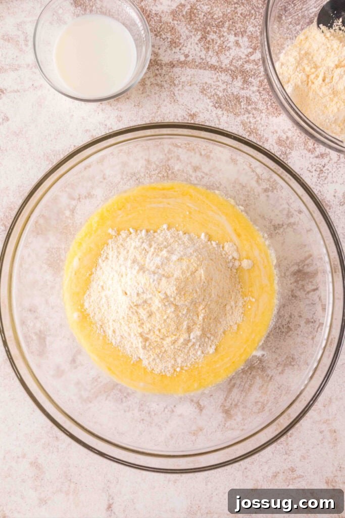 Cultured Cornbread 11 Batter partially mixed with flour and cornmeal sitting on top, before adding milk.