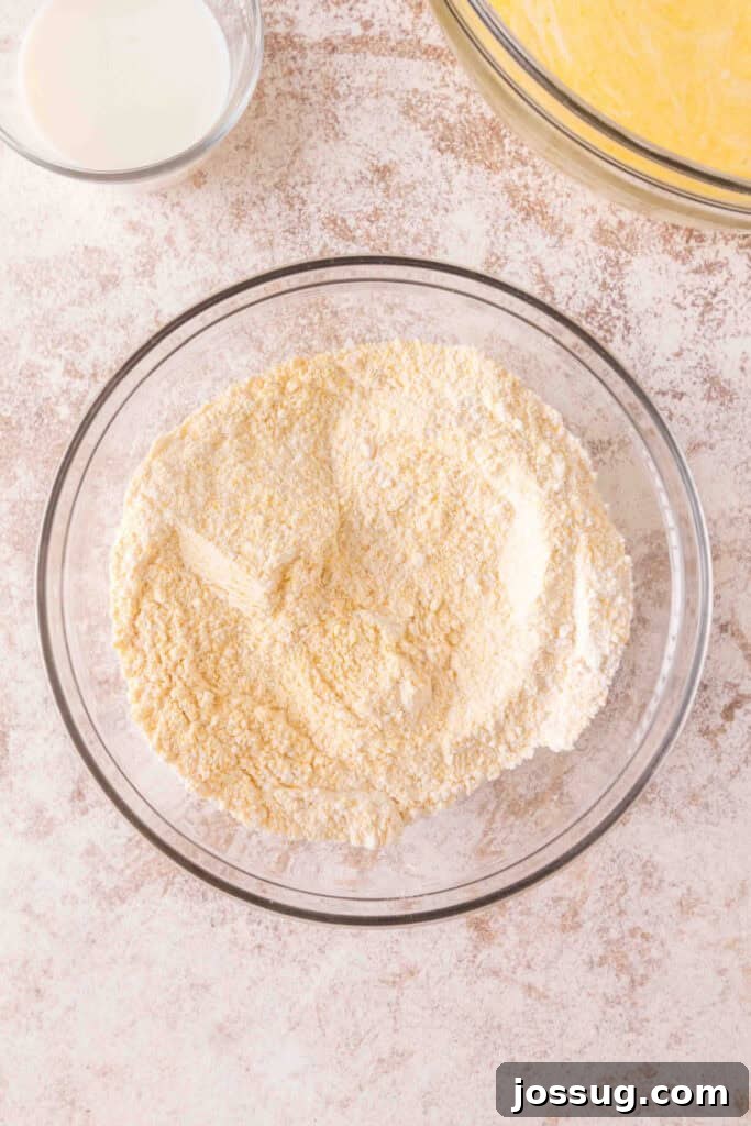 Cultured Cornbread 9 Cornmeal and flour whisked together in a mixing bowl for the dry base of cornbread.