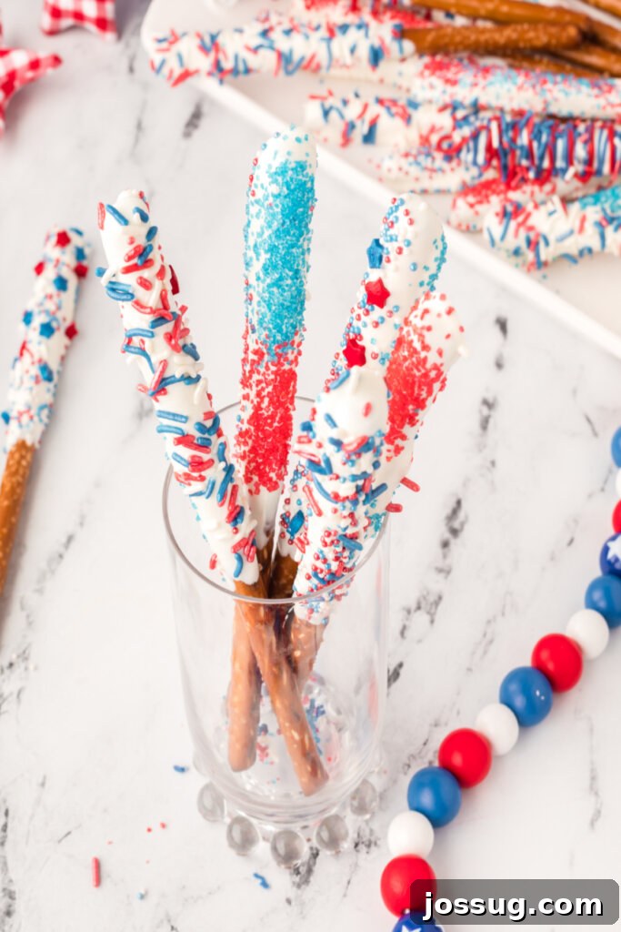 Assorted candy dipped pretzel rods in a glass jar, ready to be enjoyed.