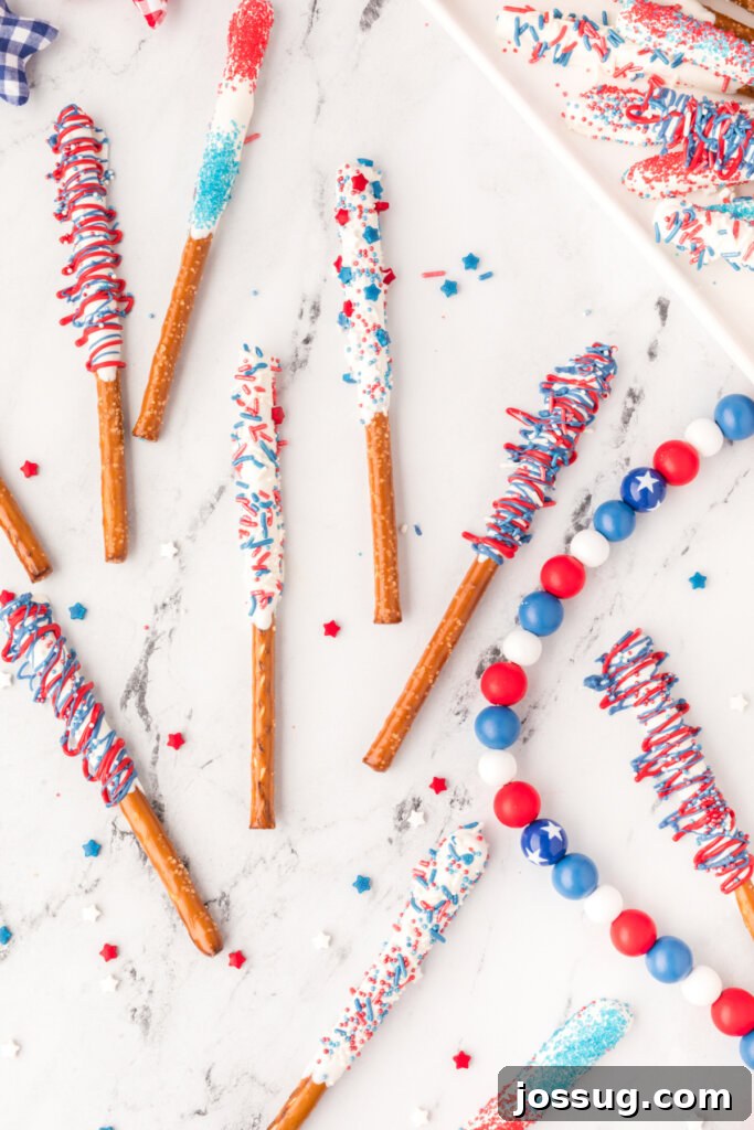 Assorted chocolate covered pretzel rods beautifully laid out on a table, ready for decorating.