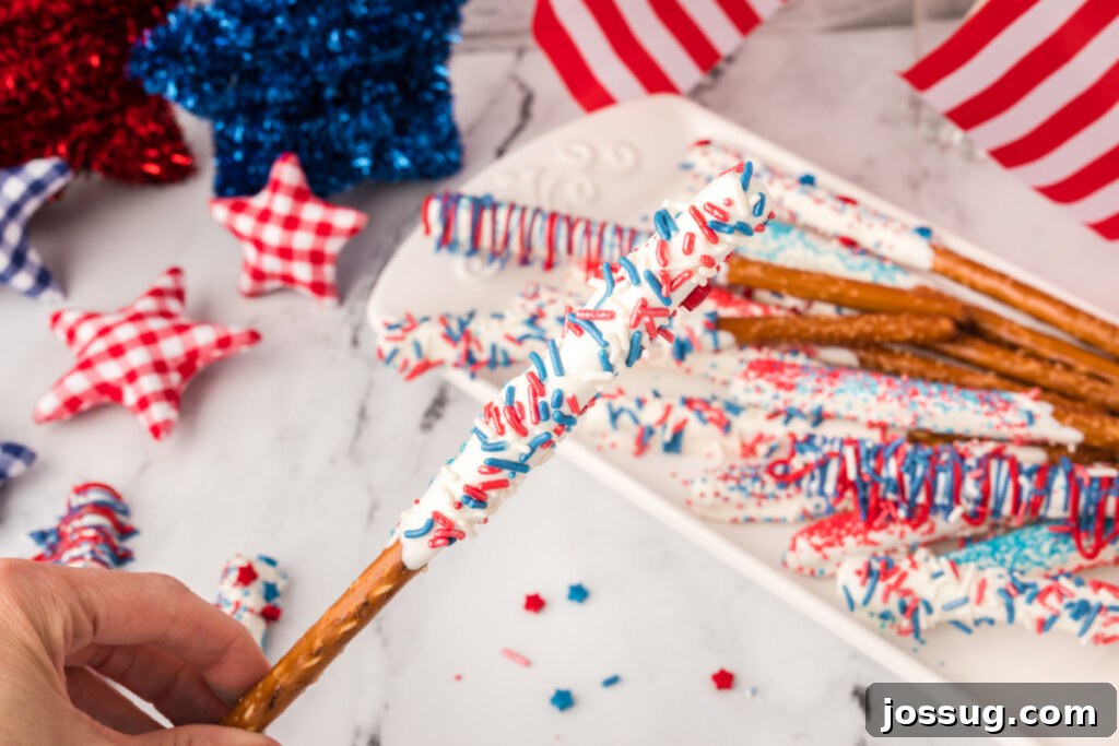 Hand holding a finished chocolate covered pretzel rod