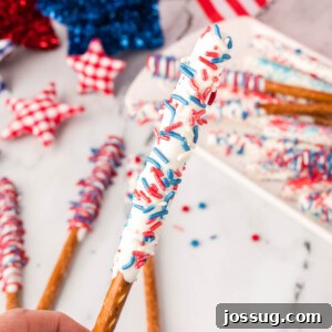 Hand holding chocolate covered pretzel rods