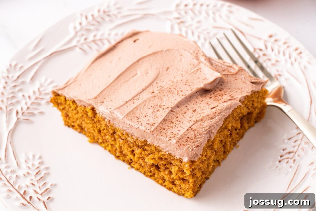 Close-up of a single pumpkin bar topped with smooth Nutella frosting, perfectly cut and presented on a decorative plate with a fork, ready to be enjoyed.