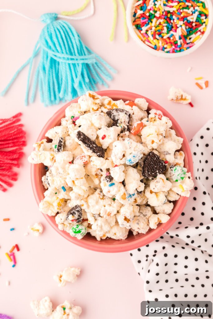 Funfetti Popcorn Treat 2 pink bowl filled with birthday cake popcorn mix