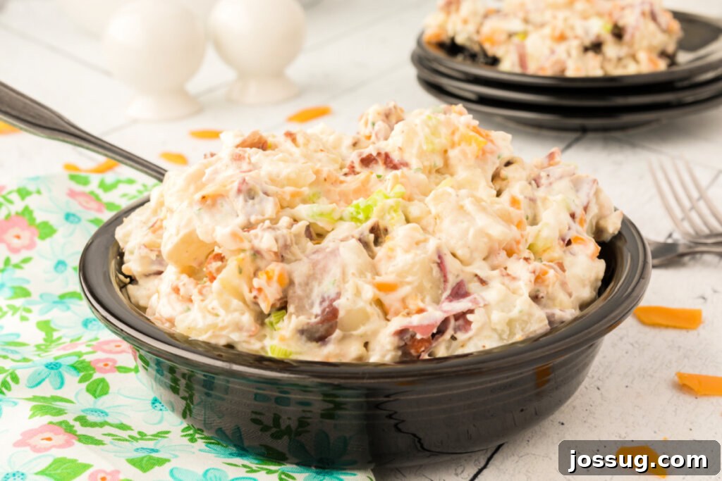 A wide shot of Bacon Ranch Potato Salad in a serving bowl, ready for a gathering, showing the vibrant ingredients.