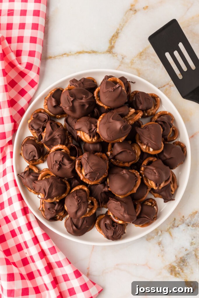 Gooey Caramel Pecan Turtles 3 Overhead view of a platter overflowing with freshly made chocolate turtle candies, ready for enjoyment.