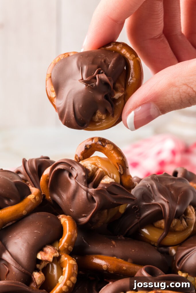 Gooey Caramel Pecan Turtles 5 Close-up detail of a single chocolate turtle candy, showing the rich chocolate drizzle, golden caramel, and a prominent pecan half.