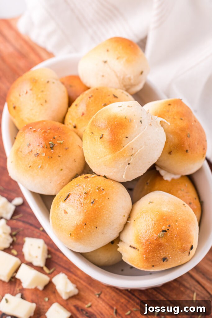 Cheesy Garlic Herb Melt-Aways 3 garlic herb cheese bombs stacked in white serving platter