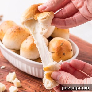 cheese pull from a garlic herb cheese bomb